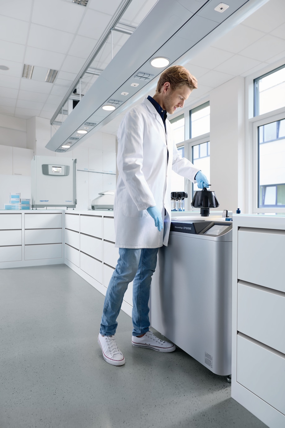 Centrifuge CP100NX, man inserting rotor, lab scene MAn inserting rotor in Centrifuge CP100NX